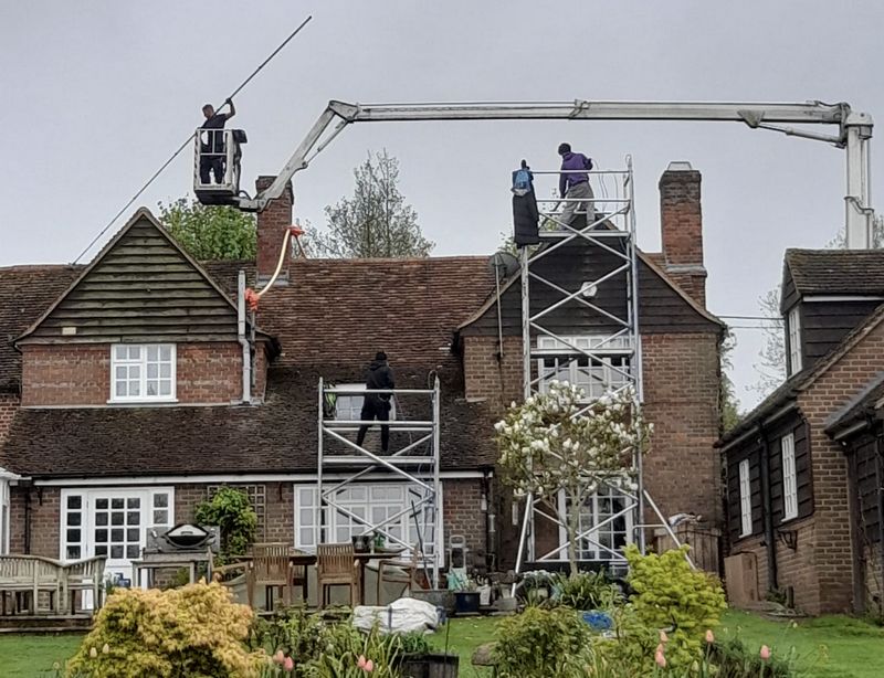 The Roof Moss Cleaners using cherry picker and scaffolding to clean roof safely and professionally in Horndean, Hampshire